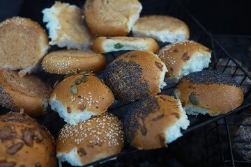 Freshly Baked Assorted Buns with Seeds and Poppy on a Cooling Rack