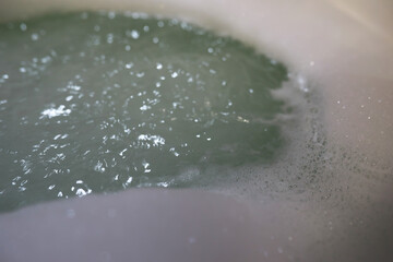 Relaxing Home Bath with Green Foamy Water for Stress Relief and Self-Care
