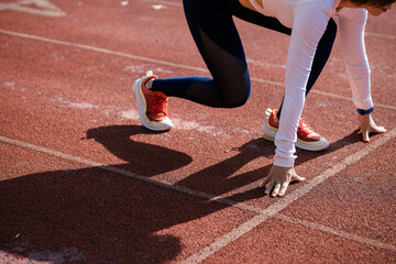 Female runner is preparing to run at the start line
