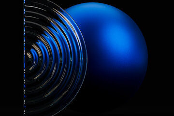 Abstract composition with a blue sphere and fluted glass on a dark background
