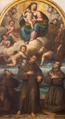 PIACENZA, ITALY - MAY 20, 2025: The painting of Madonna with the St. Francis of Assisi and holy...