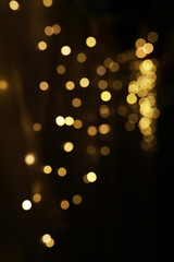 Warm Golden Bokeh Lights on Dark Background - Festive and Glowing Abstract