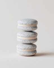 stack of macaroons, grey sesame macarons stacked vertically