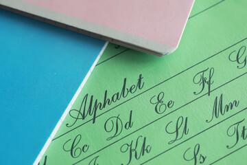 Cursive Alphabet Writing Practice on Multicolored Pages with Stationery and Educational Supplies