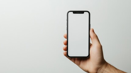 Hand holding smartphone with blank screen on light background for mockup