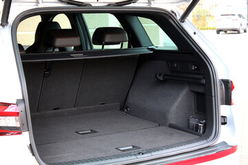 Empty car trunk open view with storage pockets. Modern hatchback SUV vehicle open cargo area. The...
