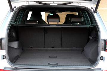 Empty car trunk open view with storage pockets. Modern hatchback SUV vehicle open cargo area. The...