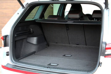 Empty car trunk open view with storage pockets. Modern hatchback SUV vehicle open cargo area. The...