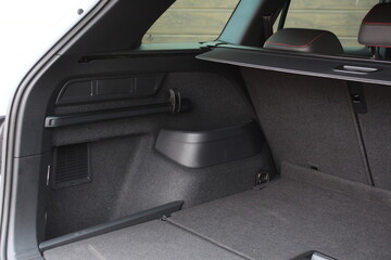 Empty car trunk open view with storage pockets. Modern hatchback SUV vehicle open cargo area. The...
