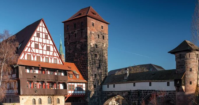 Nuremberg, Germany - December 26, 2024: Medieval Henkersteg bridge in Nuremberg&rsquo;s preserved old town. Timelapse, zoom out transition.