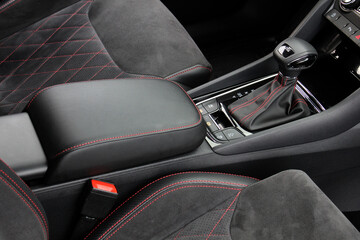 Automatic transmission of the car close-up. Interior of the new car in Alcantara with red stitching...
