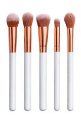 Makeup brushes arranged in a row with varying sizes and shapes, featuring white handles and rose gold ferrules. Png, Transparent background.