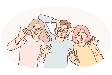 Happy girls of friend have fun making funny faces and putting fingers to faces instead of glasses