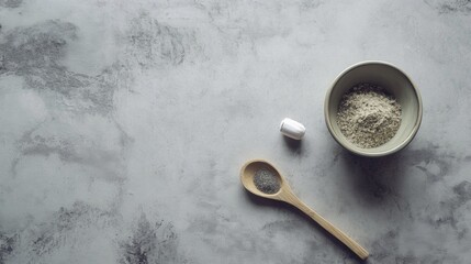 Minimalist baking setup with flour bowl and spoon on marble surface for cooking kitchen visuals