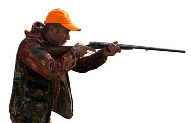 Mature man hunter with gun while walking on field.
