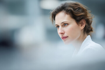 Fototapeta premium focused portrait of virologist examining samples positioned on left side of frame