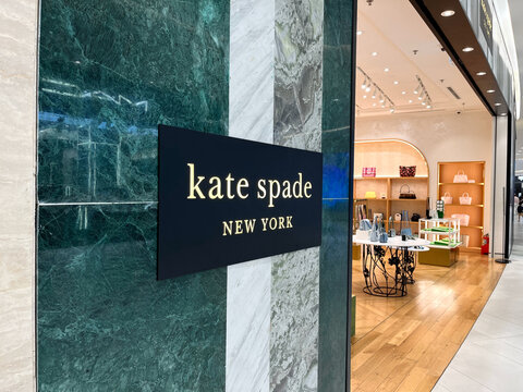 Hanoi, Vietnam - May, 24, 2025: storefront of a kate spade retail location in New York. The entrance showcases a modern design with a black and gold sign indicating the brand