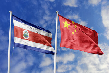 3D illustration. Costa Rica and China flags waving in the sky. High detailed waving flag. 3D render. Flags fluttered in the cloudy sky, symbolizing diplomatic relations.