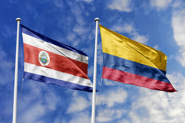 3D illustration. Costa Rica and Colombia flags waving in the sky. High detailed waving flag. 3D render. Flags fluttered in the cloudy sky, symbolizing diplomatic relations.