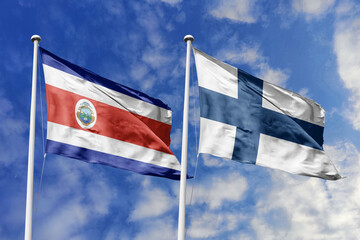 3D illustration. Costa Rica and Finland flags waving in the sky. High detailed waving flag. 3D render. Flags fluttered in the cloudy sky, symbolizing diplomatic relations.