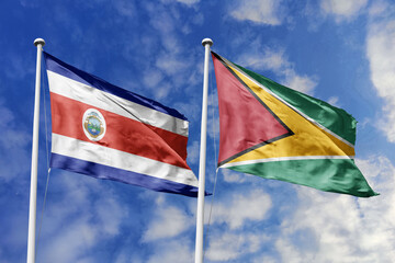 3D illustration. Costa Rica and Guyana flags waving in the sky. High detailed waving flag. 3D render. Flags fluttered in the cloudy sky, symbolizing diplomatic relations.