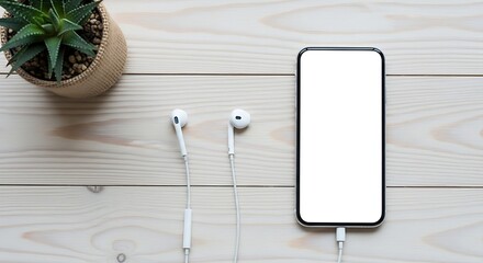Smartphone with blank screen and earphones on a wooden table with a succulent plant