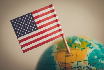 Close up flag of the United states of America marking at US geography on globe with white background copy space. America country, 4th July, geography, map, history education and so on concept.