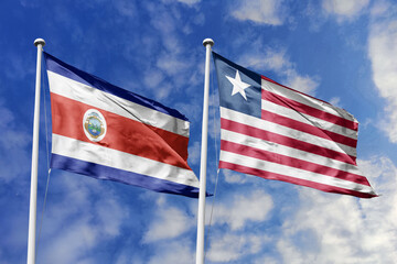 Costa Rica and Liberia flags proudly waving against a vibrant blue sky, symbolizing international...