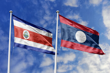 Costa Rica and Laos flags proudly waving against a vibrant blue sky, symbolizing international...
