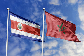 Costa Rica and Morocco flags proudly waving against a vibrant blue sky, symbolizing international...