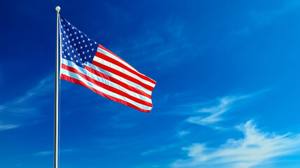 United states flag. The United States flag waves proudly on a flagpole against a bright blue sky