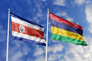 Costa Rica and Mauritius flags proudly waving against a vibrant blue sky, symbolizing international...