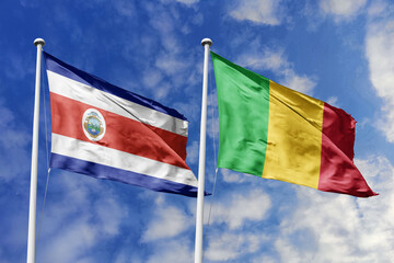 Costa Rica and Mali flags proudly waving against a vibrant blue sky, symbolizing international...
