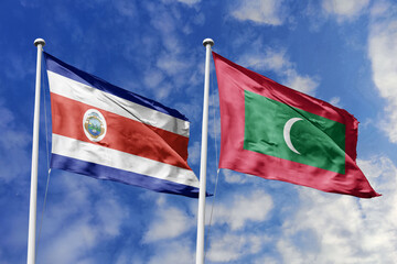 Costa Rica and Maldives flags proudly waving against a vibrant blue sky, symbolizing international...