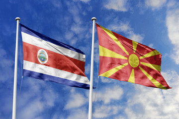 Costa Rica and North Macedonia flags proudly waving against a vibrant blue sky, symbolizing...