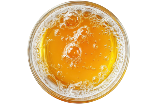 Refreshing cold orange juice with ice bubbles served in a glass on a sunny afternoon in a casual kitchen setting