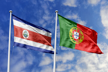 Costa Rica and Portugal National Flags Waving Proudly Under a Bright Blue Sky, Symbolizing Diplomatic Relations and Global Friendship.