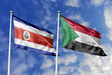 Costa Rica and Sudan National Flags Waving Harmoniously Under a Clear Blue Sky, Symbolizing Diplomatic Bonds and Global Cooperation.