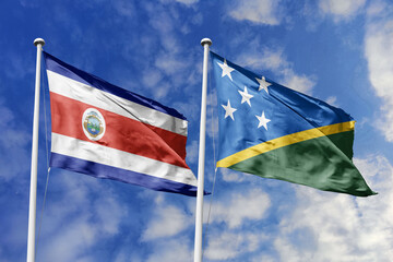 Costa Rica and Solomon Islands National Flags Waving in Harmony Against a Bright Blue Sky, Symbolizing Diplomatic Relations and Island Connections.