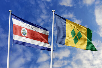 Costa Rica and Saint Vincent and the Grenadines National Flags Waving Proudly Under a Bright Blue Sky, Symbolizing Diplomatic Relations and Caribbean Connections.