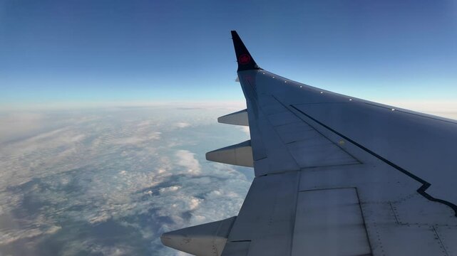Aerial view from airplane window showing clouds and Atlantic Ocean during Air Canada flight, capturing the vast expanse of water below