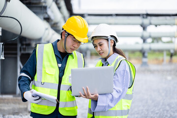 Engineer and technician working together at high voltage power substation conducting inspection and...
