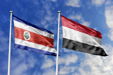 Flags of Costa Rica and Yemen Waving Together Under a Bright Blue Sky with Clouds, Symbolizing Diplomatic Ties and Middle Eastern-Central American Relations.