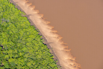 Tidal patterns below forming realistic effects formed by mudflat vegetation exposed when tide goes out in coastal Kimberleys.