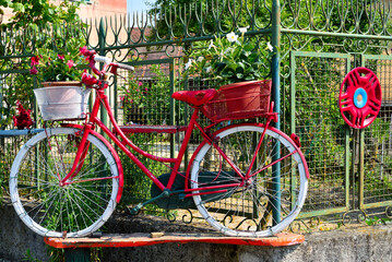 Red bicycle with flower baskets