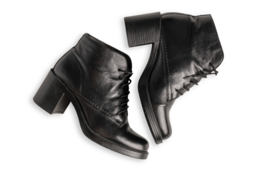 Top view of pair of black casual warm autumn season leather ankle boots with heels and laces isolated on white background used as elegant comfortable stylish female footwear shoes at cold weather