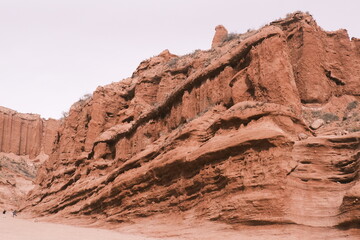 Fototapeta premium Wenisu Grand Canyon in southern Xinjiang,China, features towering, eroded red cliffs, a testament to millennia of geological evolution.