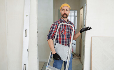 construction worker guy with a drill on a white wall background.master for an hour.