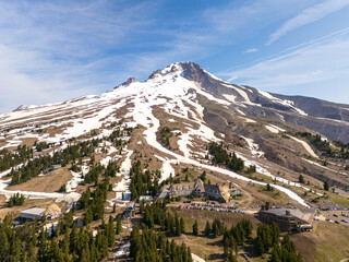 Mount Hood, summer ski in Oregon, sunshine and snow with a lodge in the foreground and ski slopes...