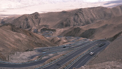 Panlong Ancient Road in Kashgar, southern Xinjiang, China,winds through mountains. Its zigzag...